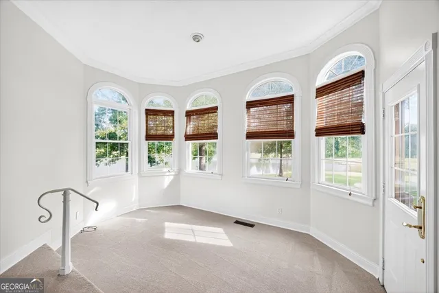 a view of a room with a chandelier fan and closet