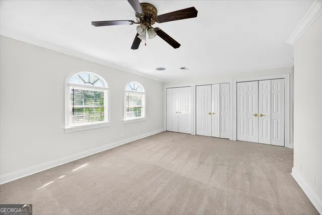 a spacious bathroom with double vanity a mirror a bathtub and a sink