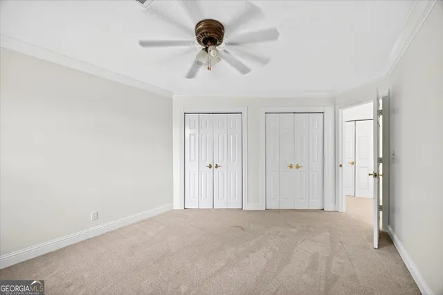 a view of a ceiling fan and a window