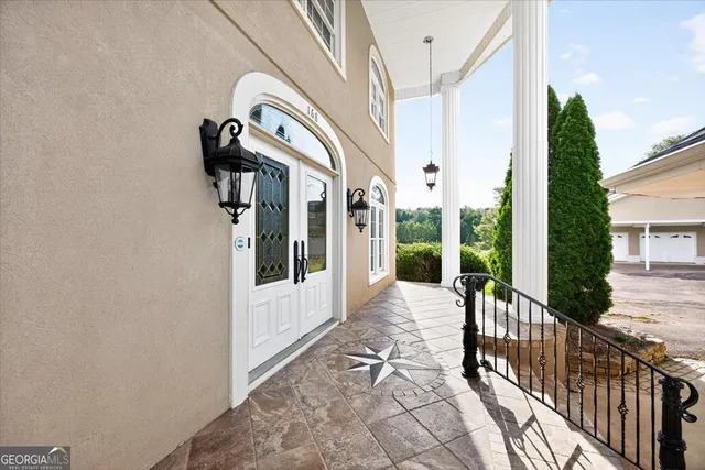 a front view of a house with swimming pool and porch