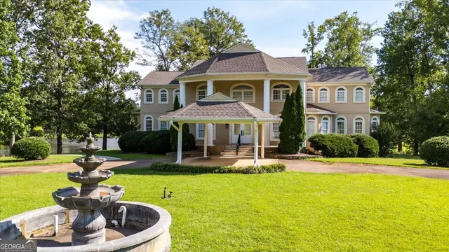 a view of a house with swimming pool and a yard