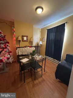 a dining room with furniture and wooden floor