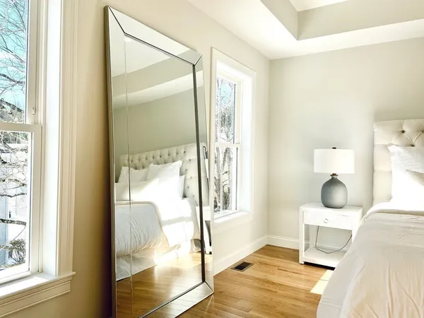 a bedroom with a bed and wooden floor