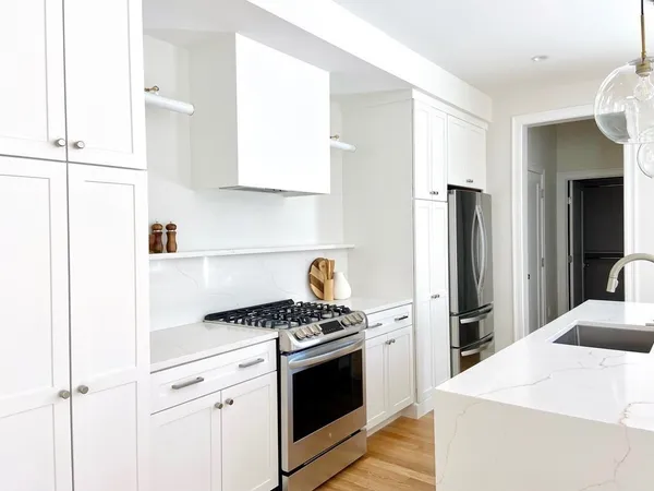 a kitchen with stainless steel appliances a refrigerator sink and stove