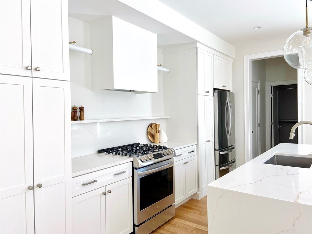 21 Quarry Road, Unit 21 Acton, MA 01720 - Photo 5 of 15 a kitchen with stainless steel appliances a refrigerator sink and stove
