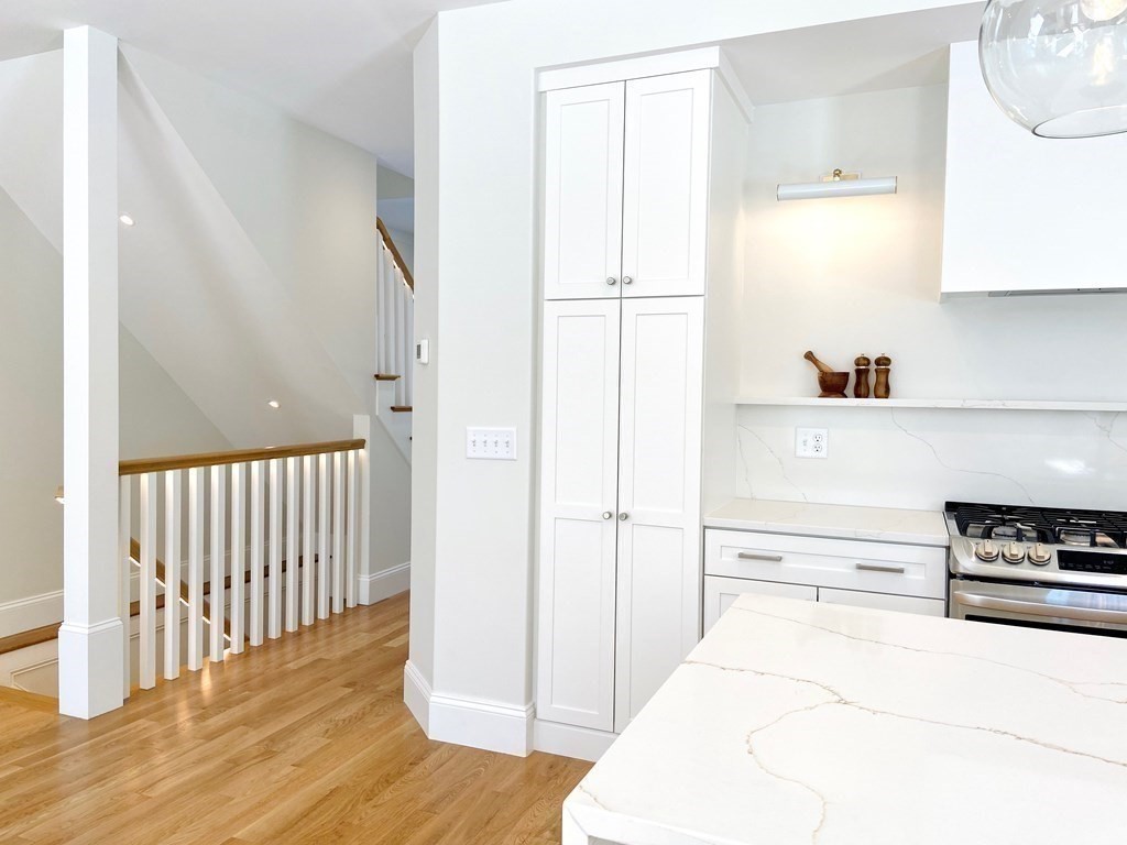 21 Quarry Road, Unit 21 Acton, MA 01720 - Photo 8 of 15 a hallway with wooden floor and cabinets