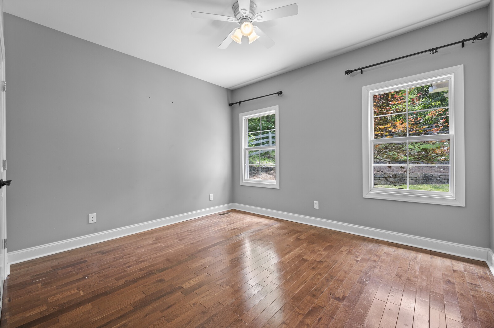1082 Meeks Cemetery Road Burns, TN 37029 - Photo 17 of 26 a view of an empty room with a window and wooden floor