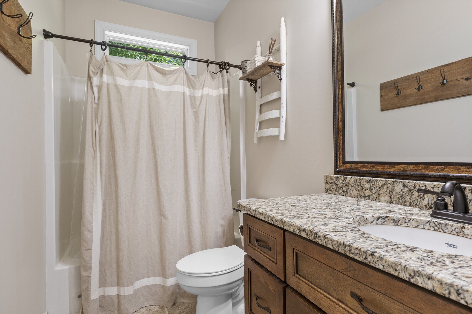 1082 Meeks Cemetery Road Burns, TN 37029 - Photo 18 of 26 a bathroom with a granite countertop sink and a mirror