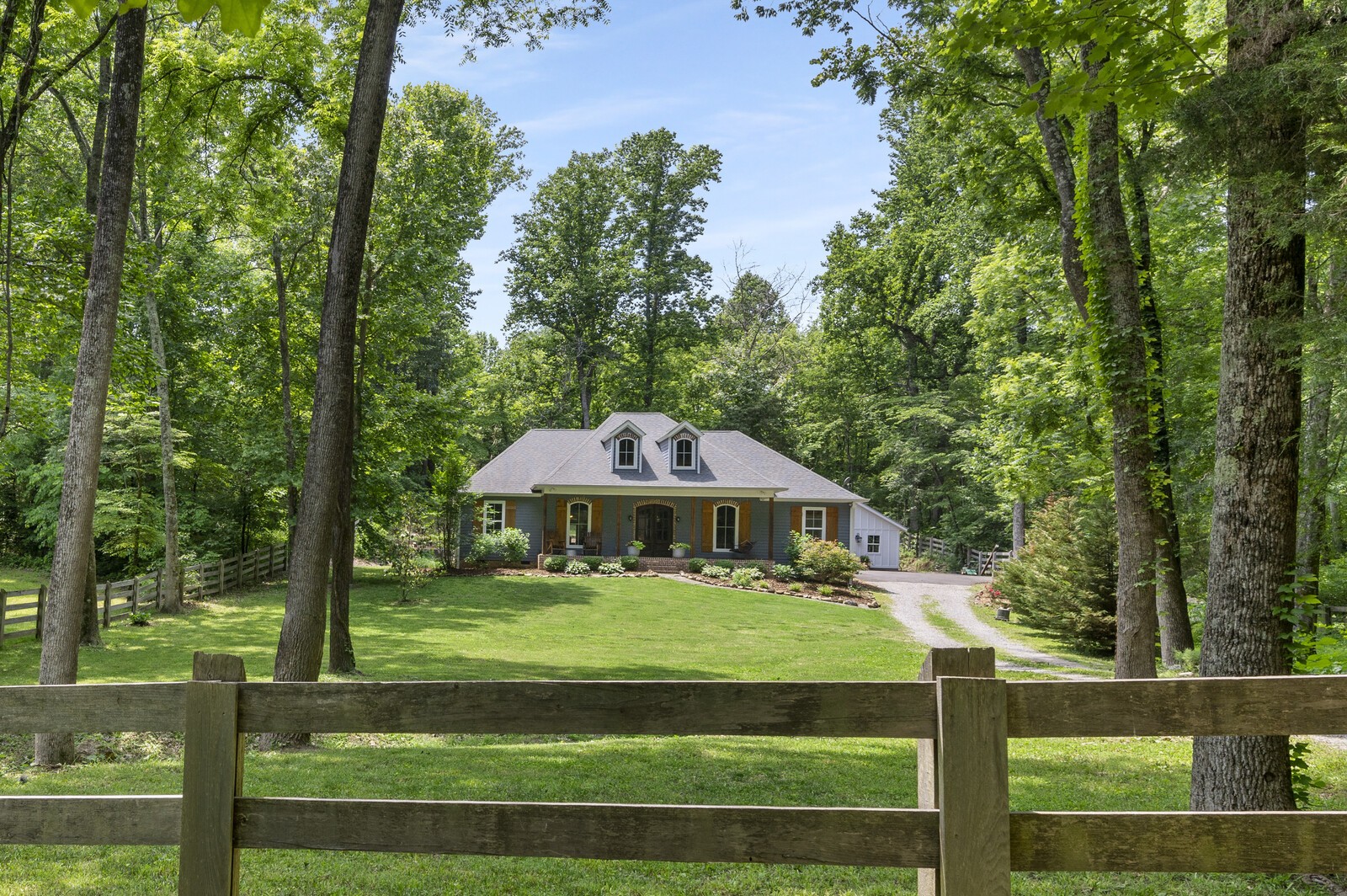 1082 Meeks Cemetery Road Burns, TN 37029 - Photo 2 of 26 a view of a table and chairs under an umbrella