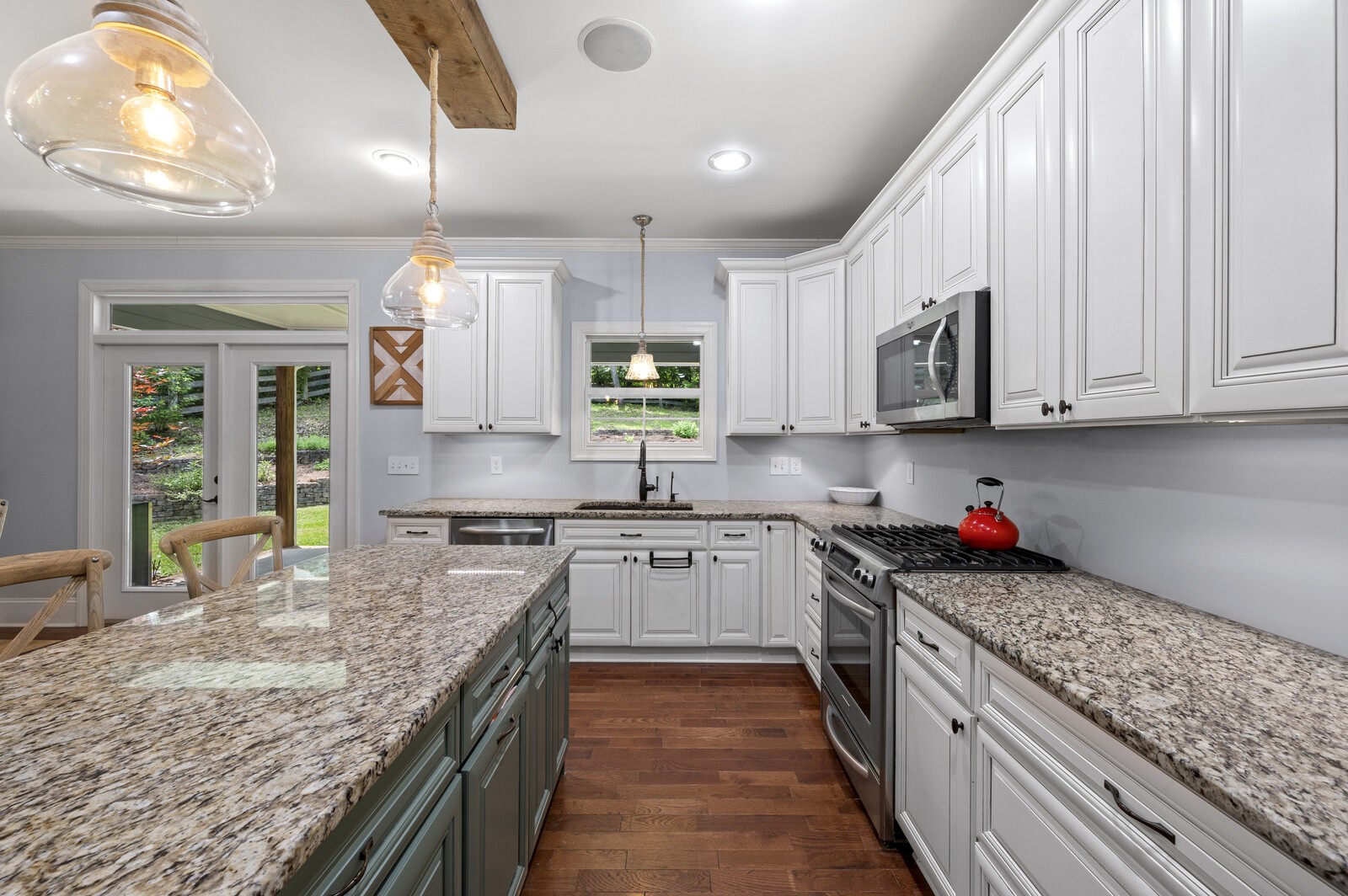 1082 Meeks Cemetery Road Burns, TN 37029 - Photo 10 of 26 a kitchen with stainless steel appliances granite countertop a stove top oven a sink dishwasher and cabinets with wooden floor