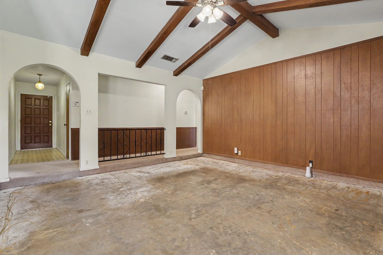 1811 Terry Lane Georgetown, TX 78628 - Photo 8 of 40 Exposed ceiling beams and vaulted ceilings define this inviting, open-concept living area.