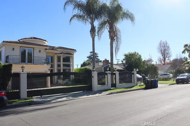 a view of a street with a cars parked in front of it