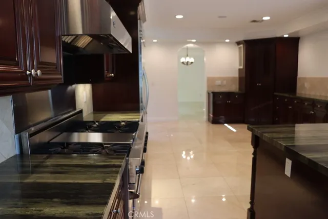 a view of an empty room with a kitchen