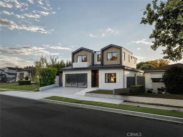 a view of house with outdoor space and parking