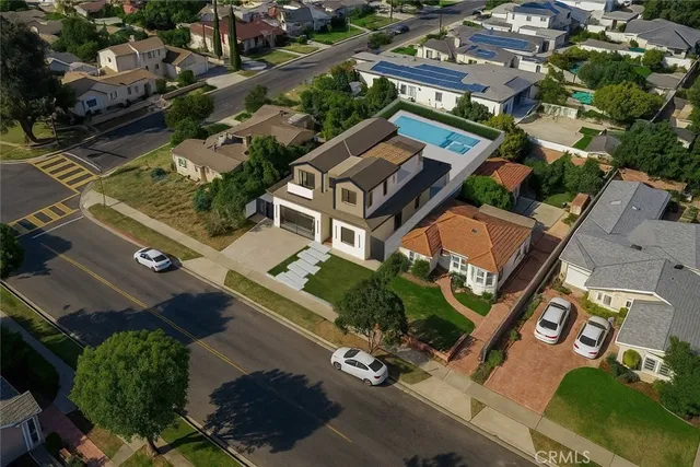 an aerial view of a residential apartment building with a yard