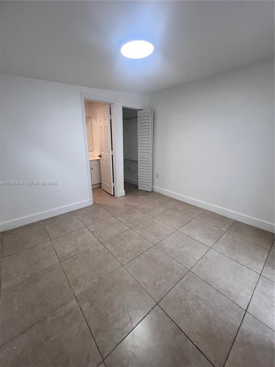 14763 Southwest 173rd Terrace, Unit 1 Miami, FL 33187 - Photo 12 of 23 a view of an empty room with a window