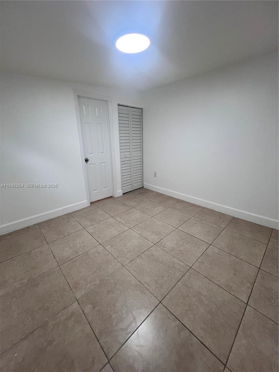 14763 Southwest 173rd Terrace, Unit 1 Miami, FL 33187 - Photo 19 of 23 a view of an empty room with a window