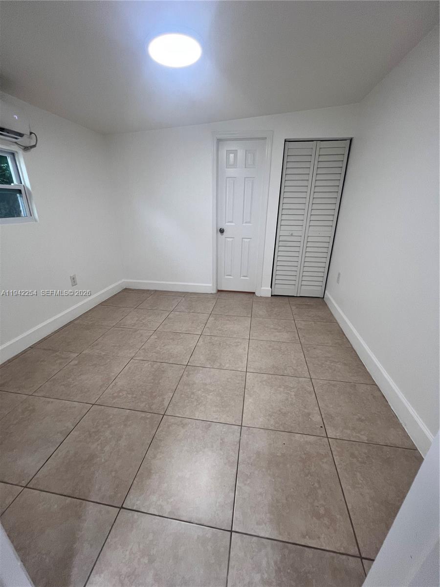 14763 Southwest 173rd Terrace, Unit 1 Miami, FL 33187 - Photo 20 of 23 a view of a livingroom with an empty space and a window