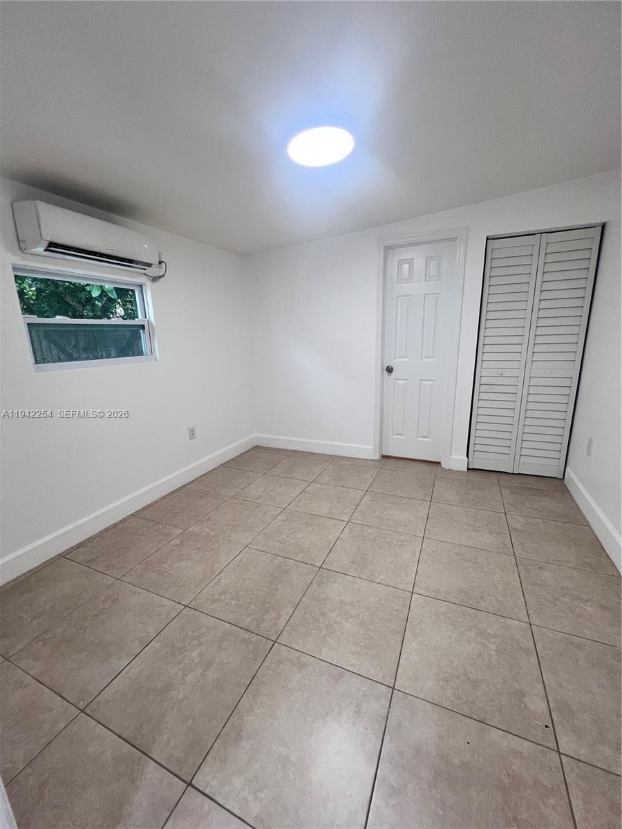 14763 Southwest 173rd Terrace, Unit 1 Miami, FL 33187 - Photo 21 of 23 a view of an empty room with a window