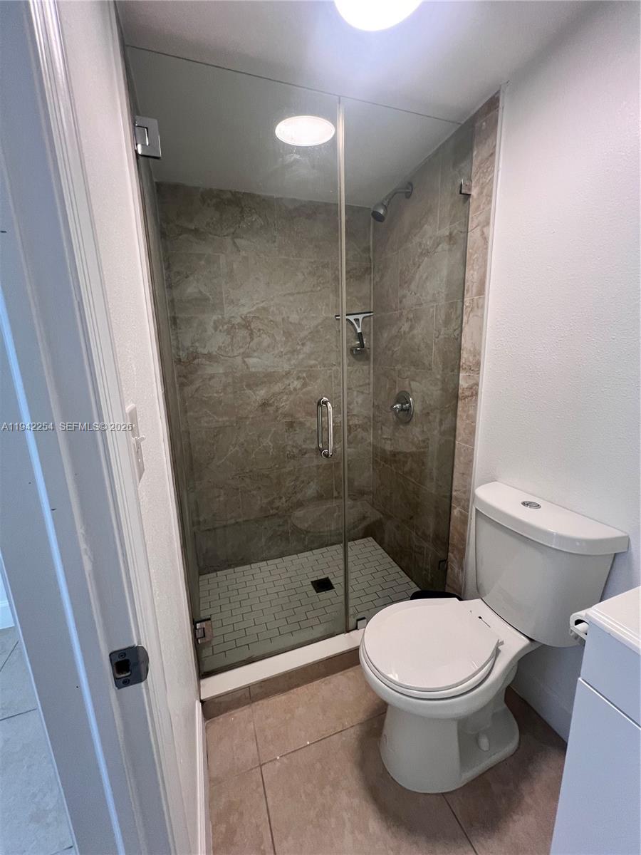 14763 Southwest 173rd Terrace, Unit 1 Miami, FL 33187 - Photo 22 of 23 a bathroom with a toilet and a shower