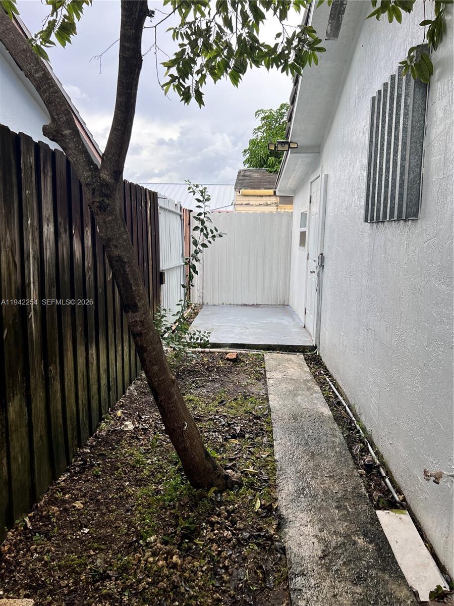 14763 Southwest 173rd Terrace, Unit 1 Miami, FL 33187 - Photo 4 of 23 a view of a yard with wooden fence
