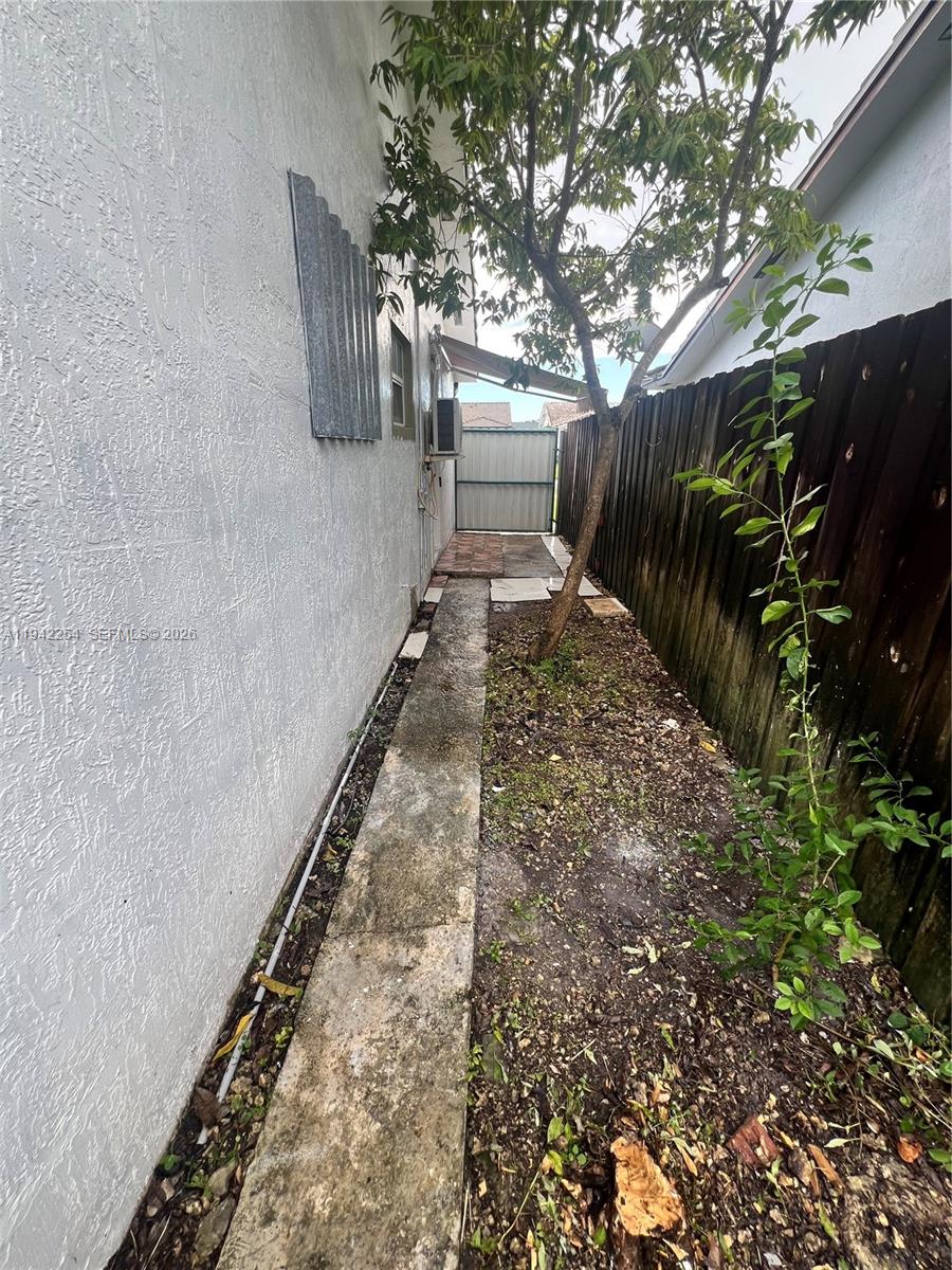 14763 Southwest 173rd Terrace, Unit 1 Miami, FL 33187 - Photo 5 of 23 a view of a yard with wooden fence