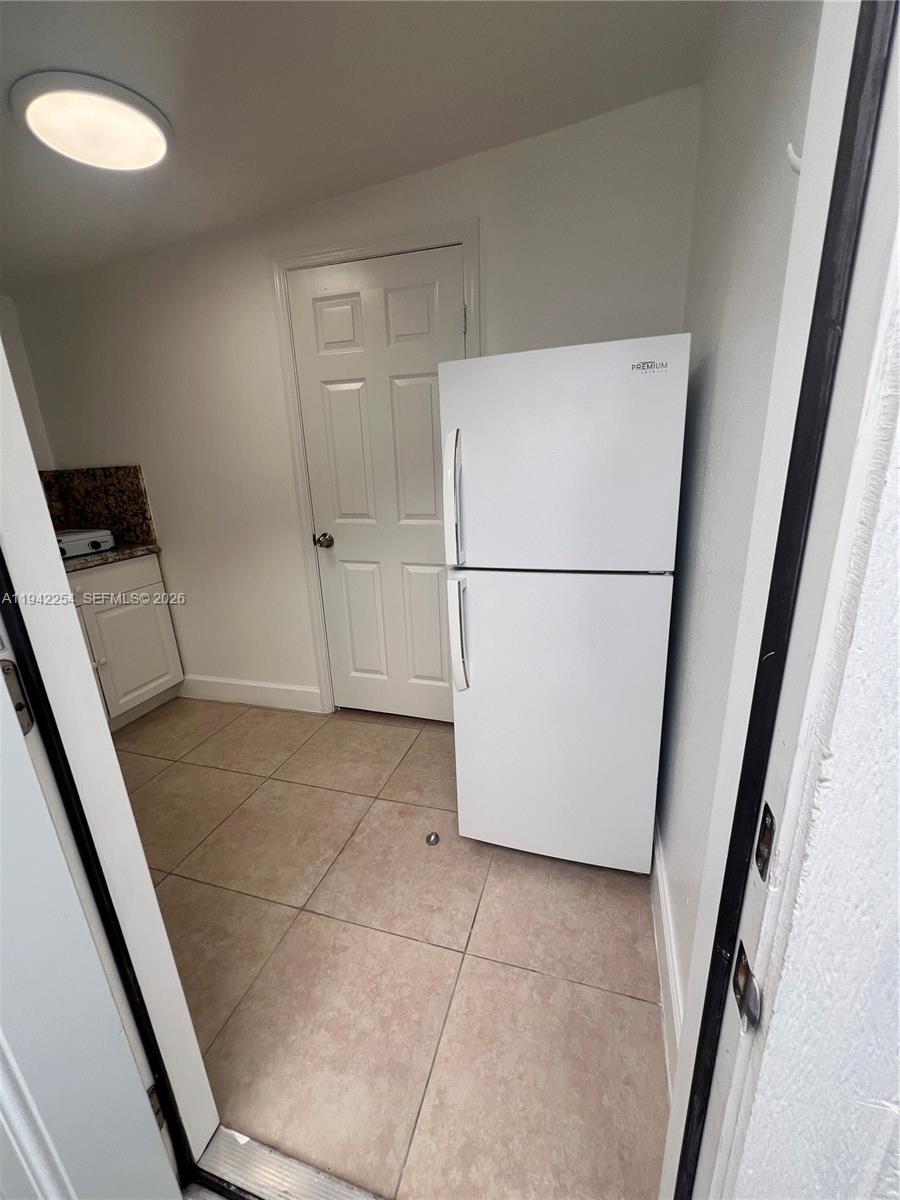 14763 Southwest 173rd Terrace, Unit 1 Miami, FL 33187 - Photo 7 of 23 a white refrigerator freezer and a dishwasher in a kitchen