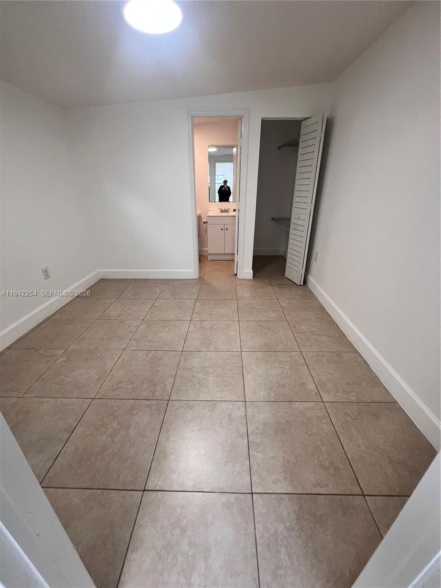 14763 Southwest 173rd Terrace, Unit 1 Miami, FL 33187 - Photo 10 of 23 a view of an empty room and fire place