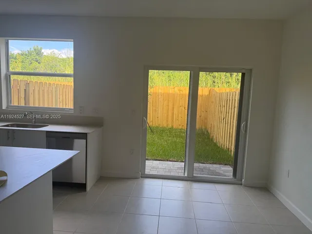 a kitchen with a refrigerator and a sink