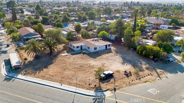 an aerial view of a house with a yard basket ball court and outdoor seating