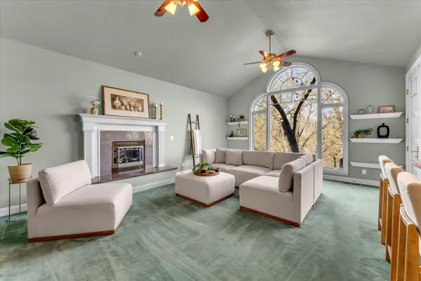 a living room with furniture a fireplace and a large mirror