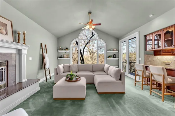 a living room with furniture and a chandelier