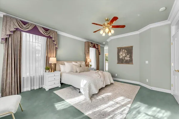 a bedroom with a bed mirror and a window