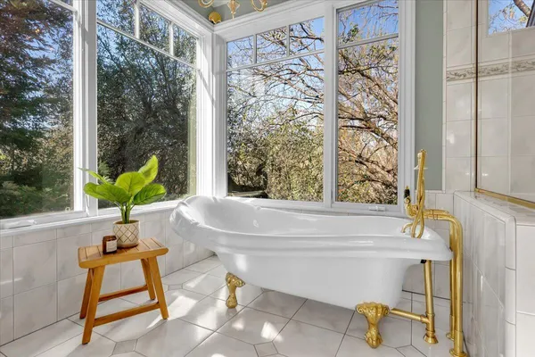 a bathroom with a bathtub and window