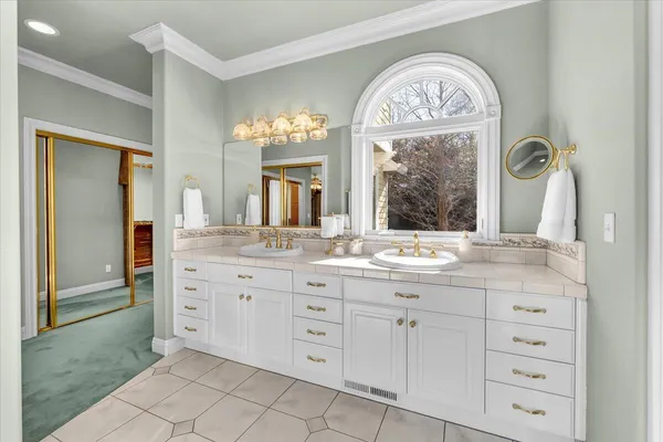 a bathroom with a granite countertop sink a mirror and a window