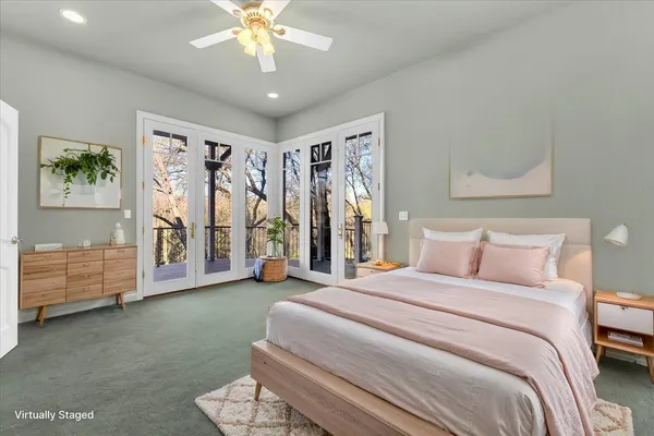 a spacious bedroom with a bed and a chandelier