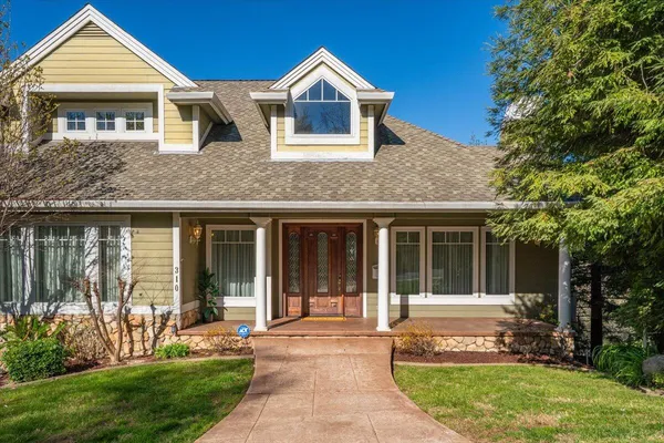 a front view of a house with a yard and porch