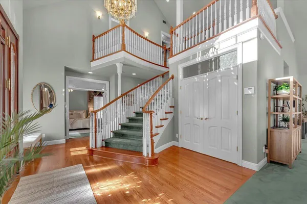a view of entryway and hall with wooden floor