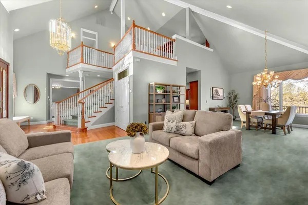 a living room with furniture and a large mirror