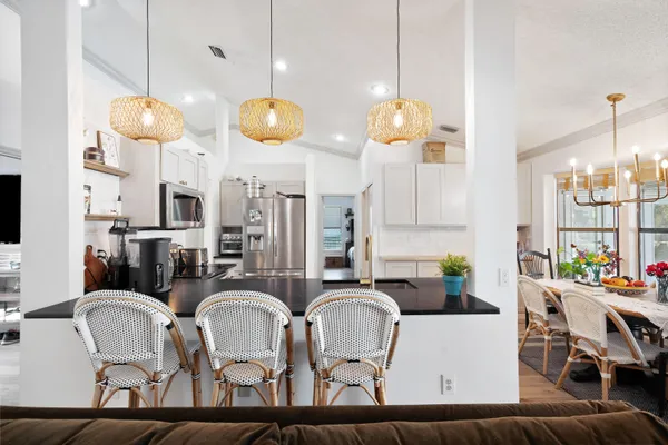 a kitchen with dining table and chairs