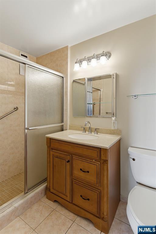 280 Prospect Avenue, Unit 8G Hackensack, NJ 07601 - Photo 18 of 23 a bathroom with a granite countertop sink toilet and shower