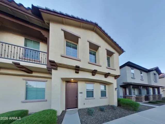 a view of a white house with large windows