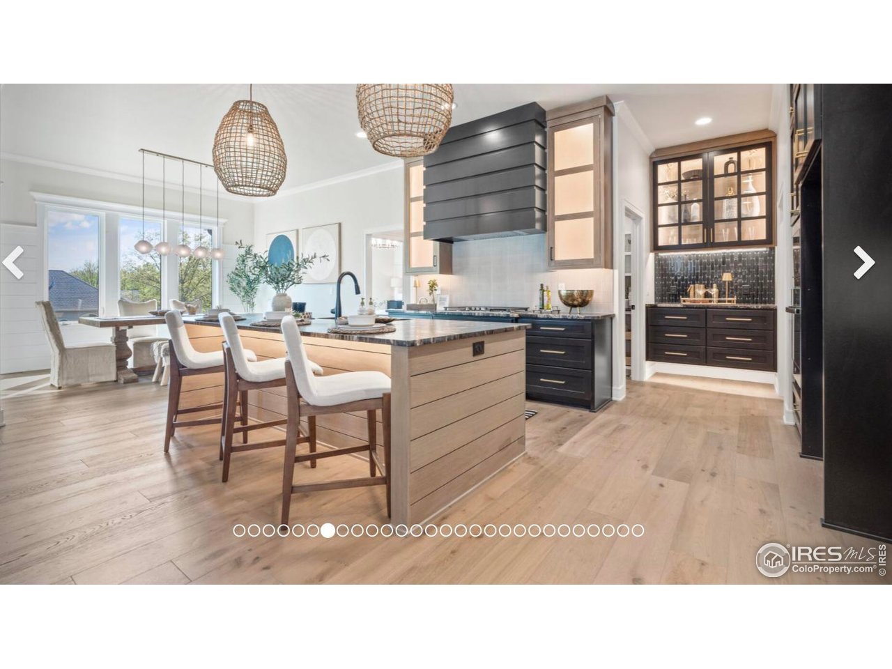 3806 Bridle Ridge Circle Severance, CO 80524 - Photo 13 of 13 a living room with couches a dining table and kitchen view with wooden floor