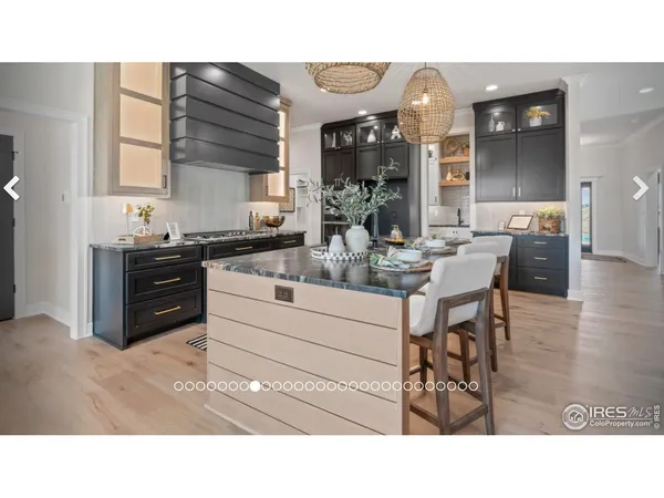a living room with couches a dining table and kitchen view with wooden floor