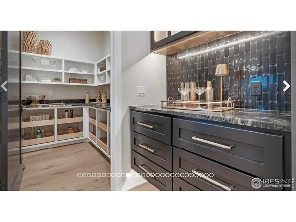 a kitchen with a sink a table and chairs