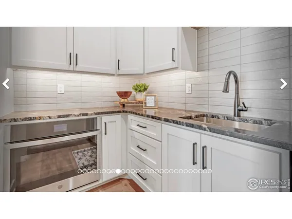 a black and white kitchen with a sink