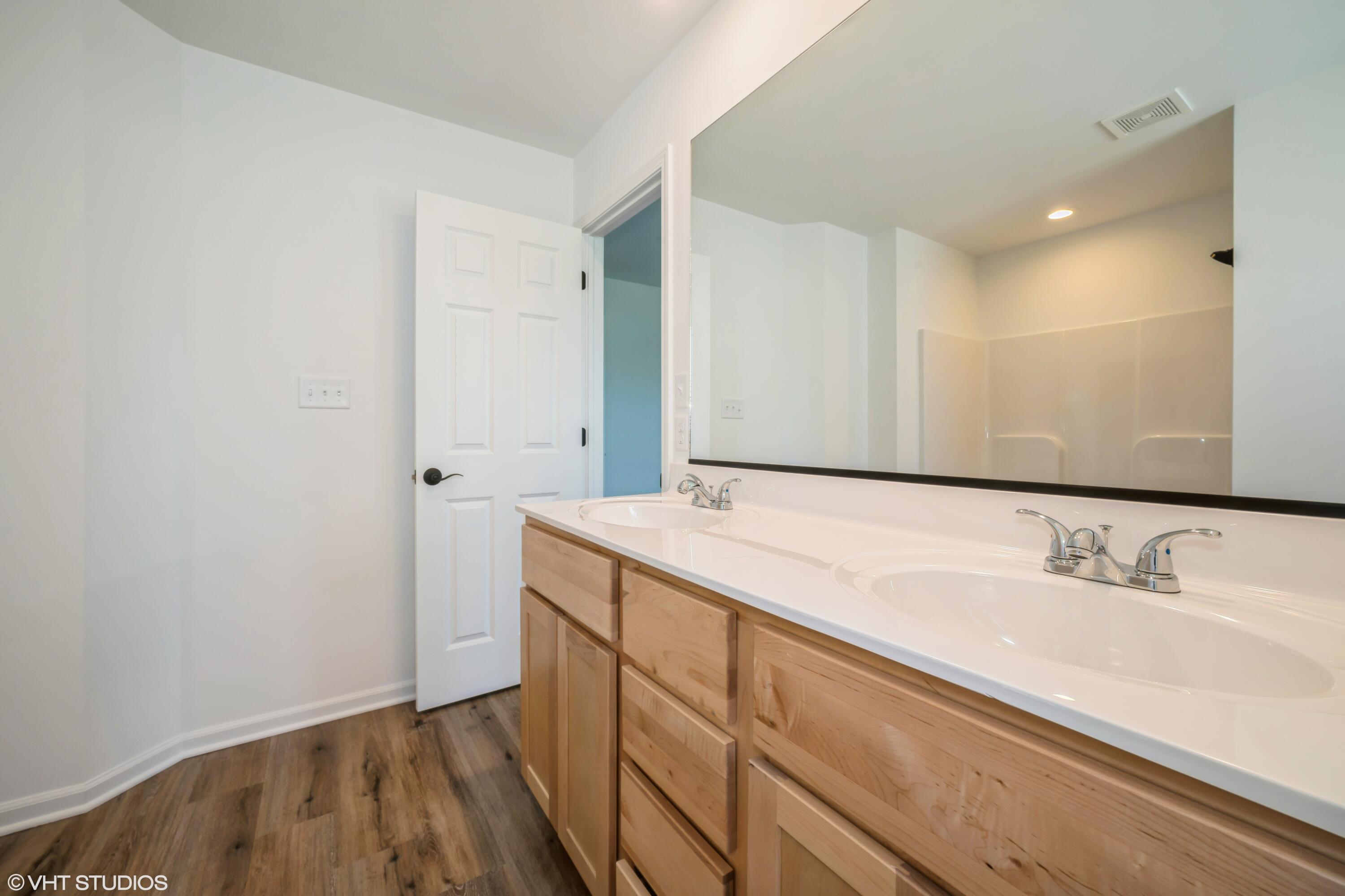 2885 East 105th Avenue Crown Point, IN 46307 - Photo 25 of 30 a bathroom with a sink and a mirror
