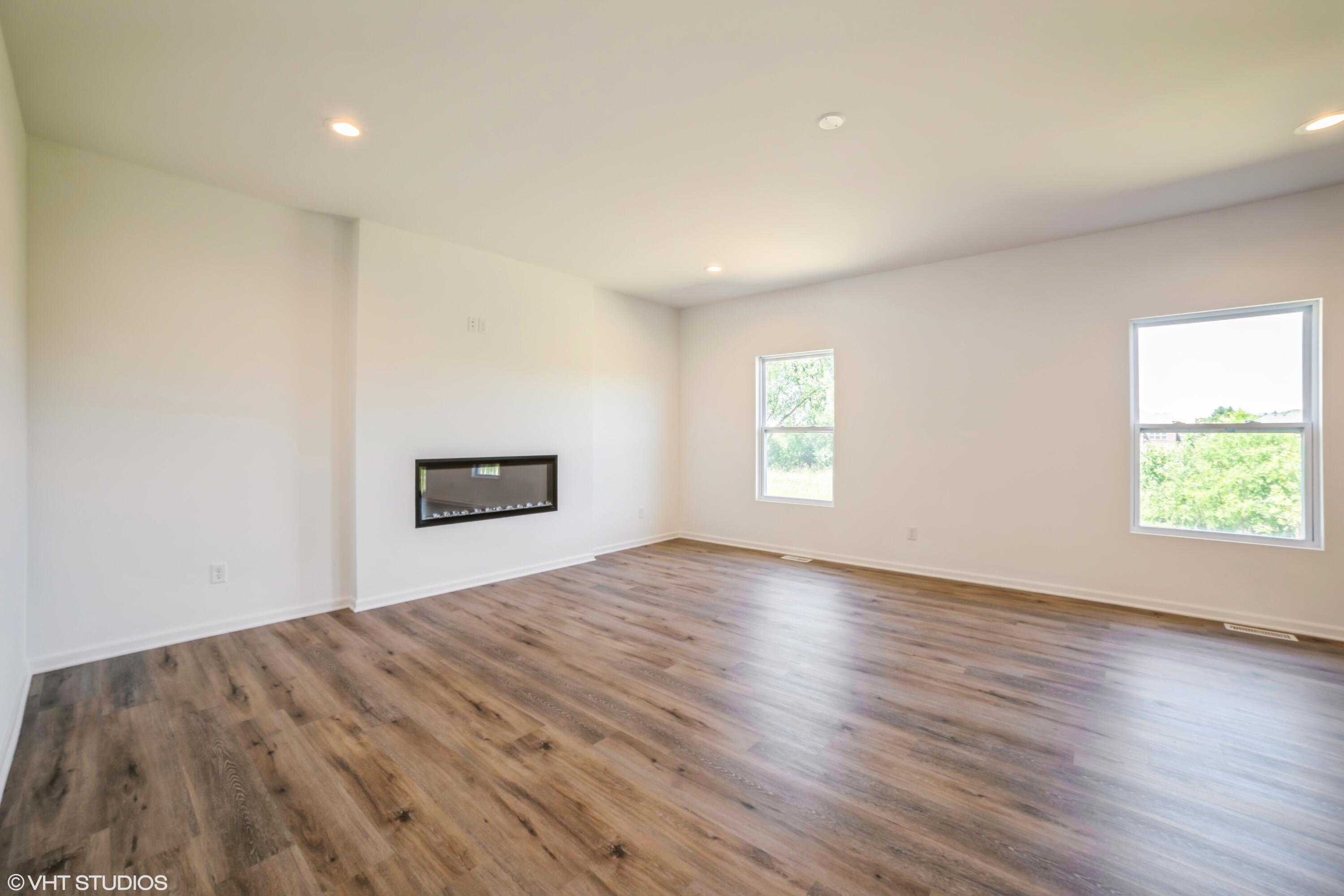 2885 East 105th Avenue Crown Point, IN 46307 - Photo 8 of 30 an empty room with wooden floor and windows