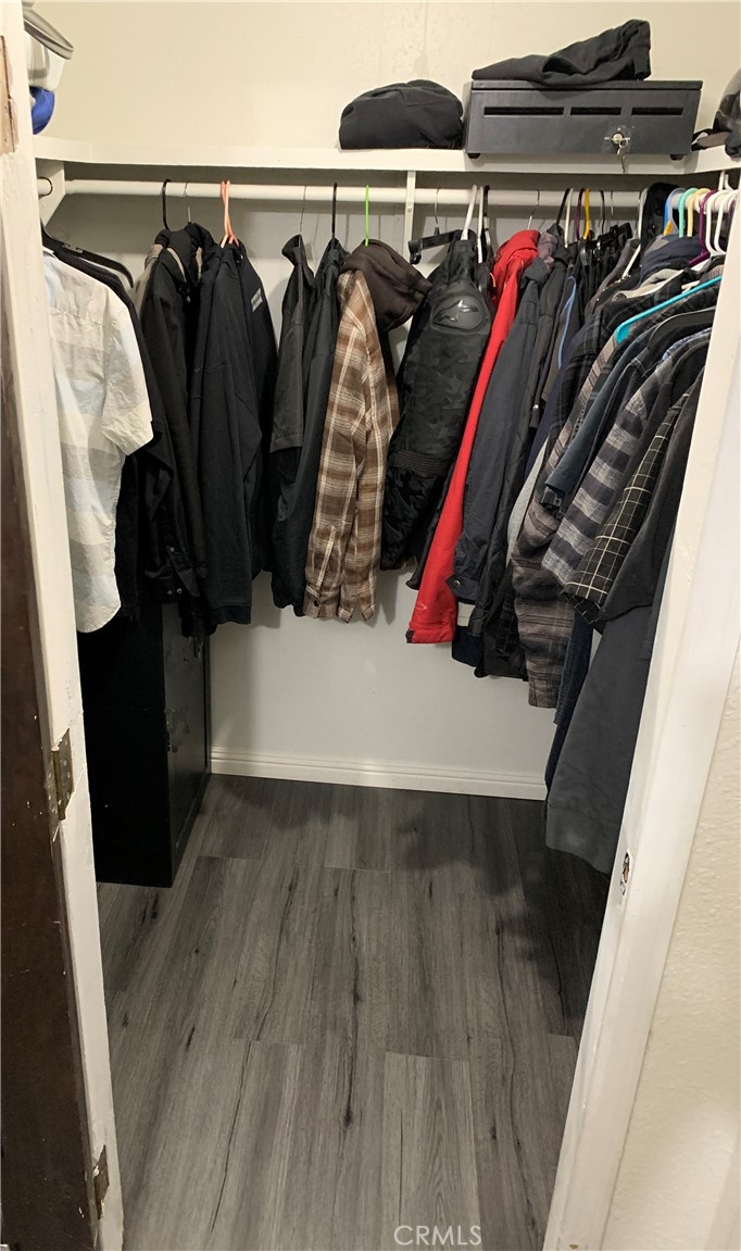20415 Myron Street Perris, CA 92570 - Photo 15 of 29 a view of walk in closet with clothes and shoes