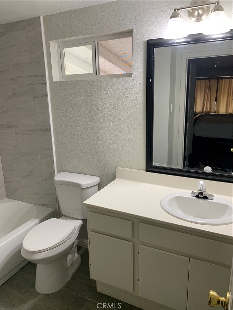20415 Myron Street Perris, CA 92570 - Photo 16 of 29 a bathroom with a sink a toilet and mirror